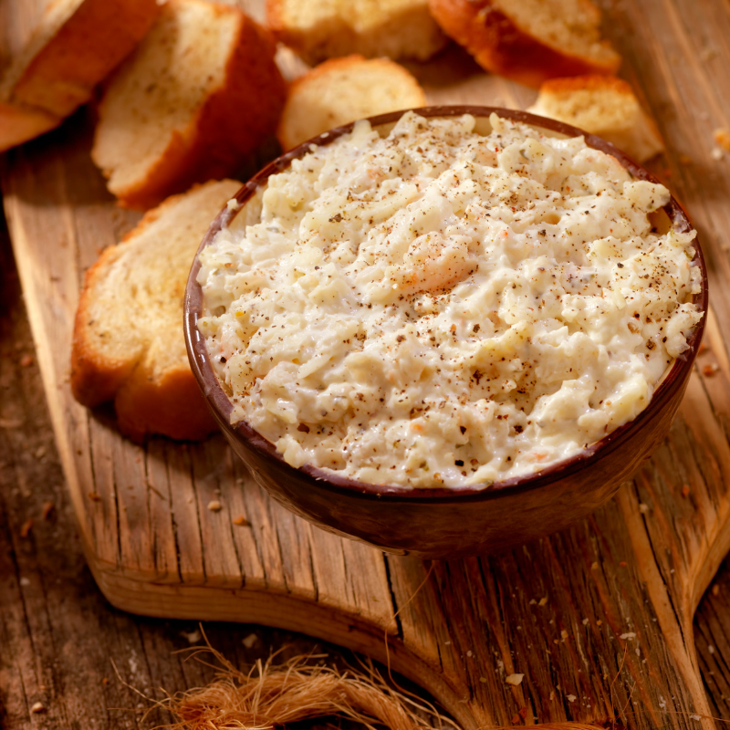 Bacon Crab Dip in a bowl with a side of baguette slices.