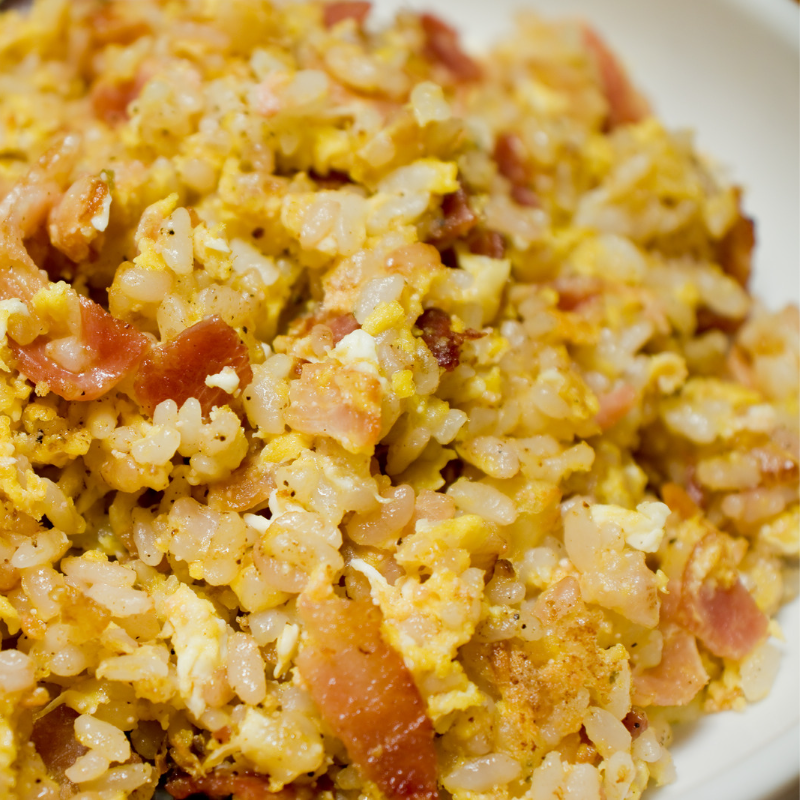 Close-up of rice with bacon and eggs