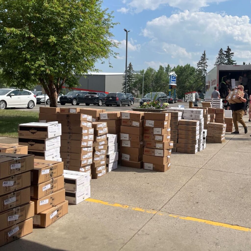 Volunteers sort boxes of food before pickup.