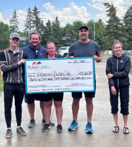 Wolverines Hockey Club, delivery in Calgary, June 2023. Holding cheque of all time raised over $36,000.