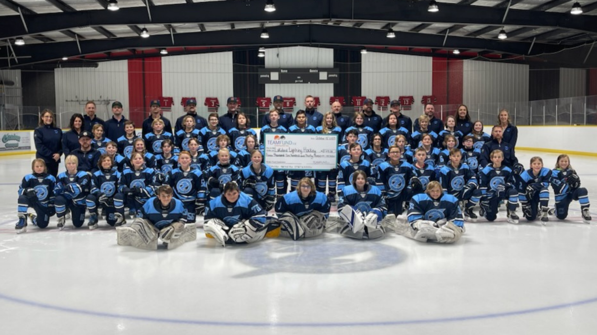 Wolverines Hockey Club, delivery in Calgary, June 2023. Holding cheque of all time raised over $36,000.