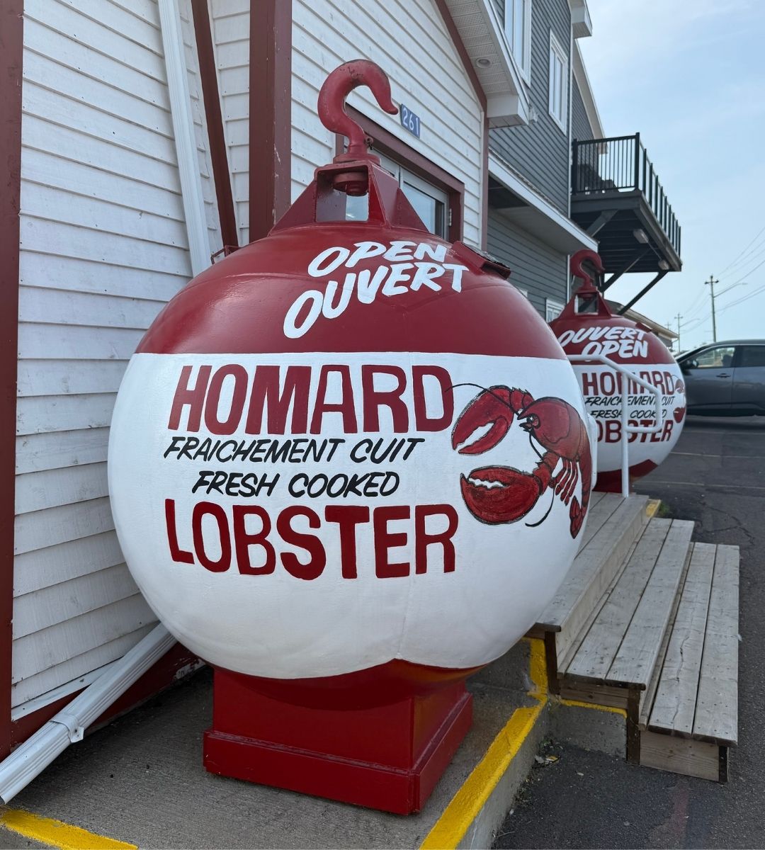 bilingual-fresh-cooked-lobster-buoy Giant lobster buoy outside a seafood shop in Shediac, New Brunswick.