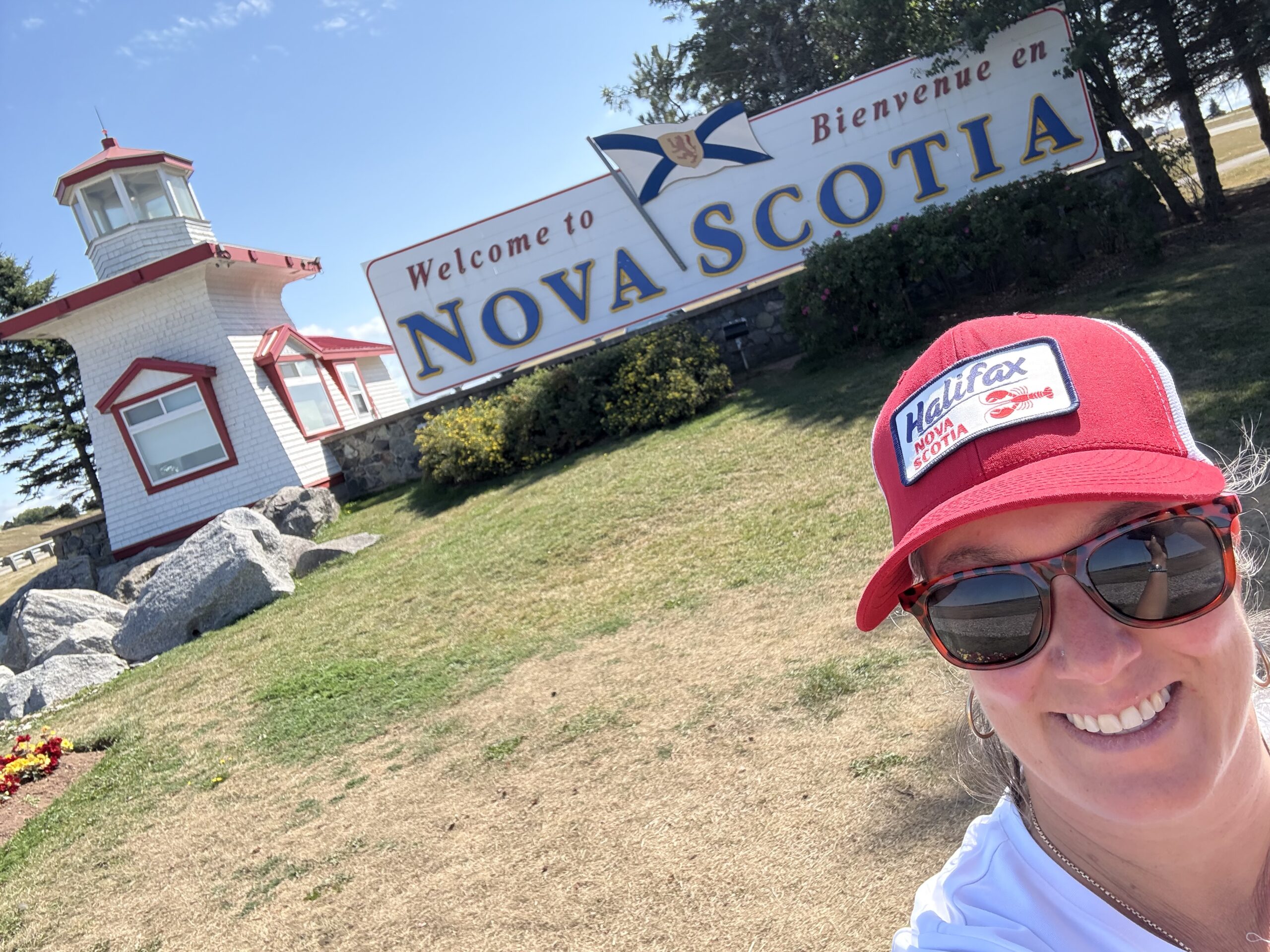 welcome-to-nova-scotia-teamfund-fundraising-expansion Dominique from TeamFund standing at the āWelcome to Nova Scotiaā sign, marking the start of TeamFundās Maritimes expansion.